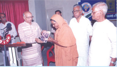 2001 July 18 : Justice Chandrasekhar Darmadhikari is releasing the book Woman-ManRelations:A GandianApproach authored by Dada Dharmadhikari by presenting the first copy to Parivragik Rajamma. Gandhi Smarakanidhi Chairman P. Gopinathan Nair looks on.