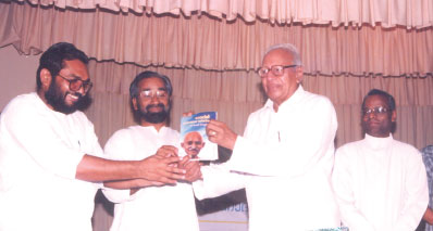 2002 June 14 : Justice V.R. Krishna Iyer is releasing the first copy of the book Gandhiji: Navothana Daarsanikan authored by Dr. K.S.Radhakrishnan, by presenting the first copy to Dr. N. Radhakrishnan. On the stage are Dr. K.S. Radhakrishnan, Rev. Father Dr. Paul Thelakkad, etc.